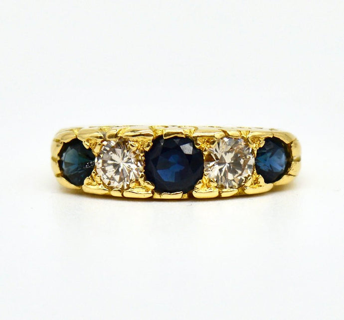 An early 20th century 18ct gold 5-stone sapphire and diamond half hoop ring